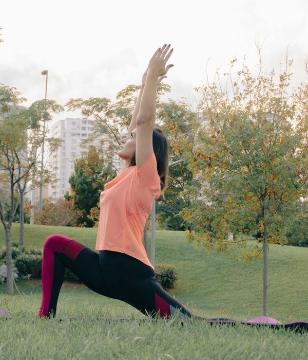 Woman in a calm yoga pose, embodying peace and flexibility.